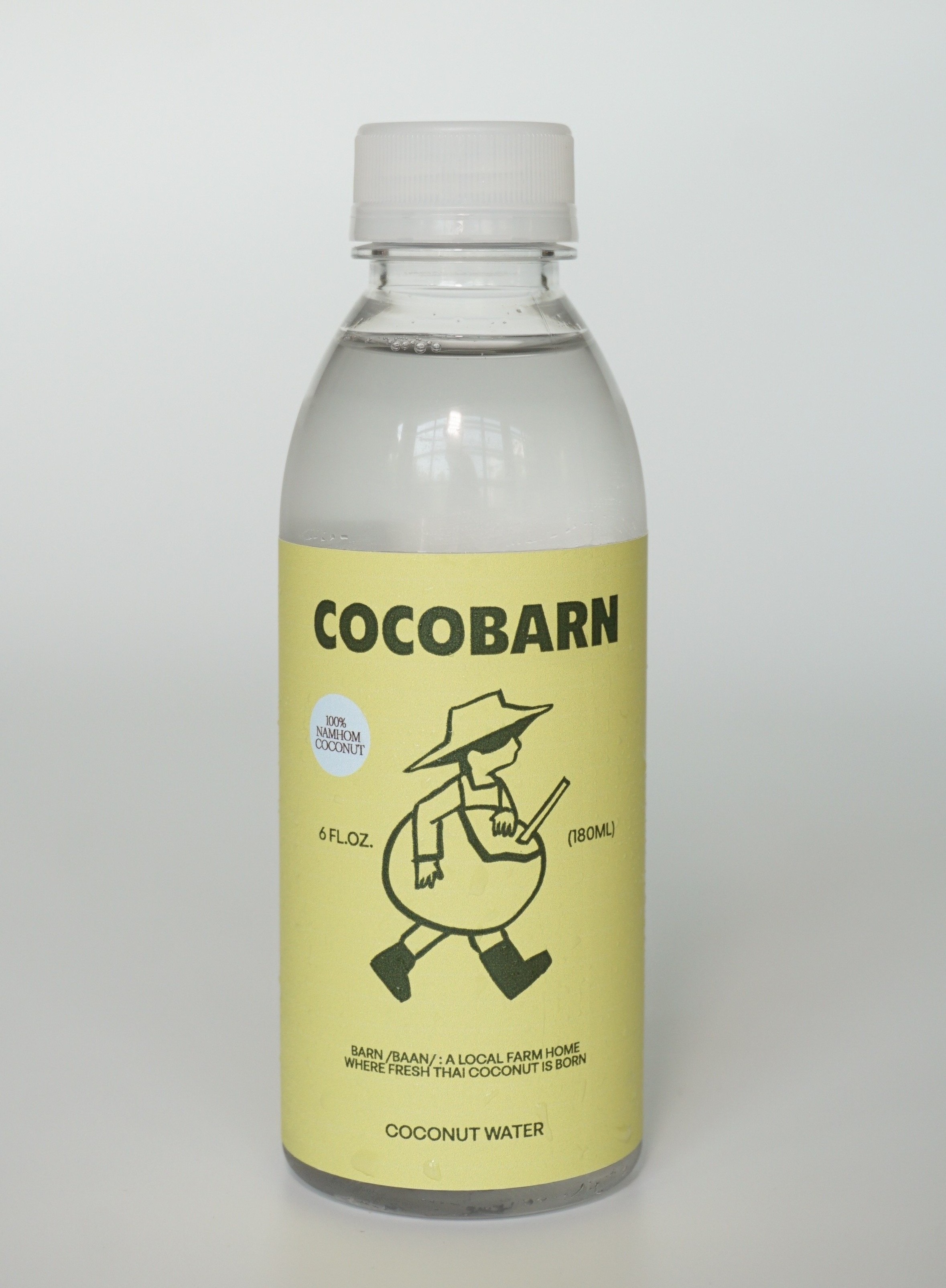 COCOBARN coconut water bottle front label — branding with farmer mascot, 180ml and 1L sizes